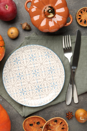 Stylish place setting and autumn decor on gray textured tableの写真素材