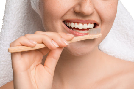 Woman brushing her teeth on white background, closeupの写真素材