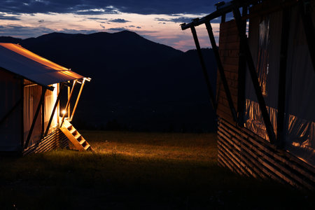 Tents in mountains at night. Glamping siteの写真素材