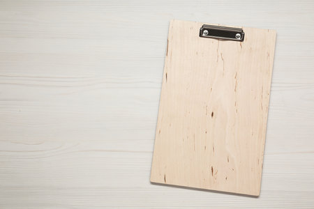 One clipboard on wooden table, top view. Space for textの写真素材