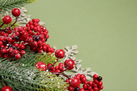 Fir tree branches and Christmas decor on green background, closeup. Space for textの写真素材