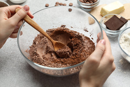 Woman making chocolate dough at light table, closeupの写真素材