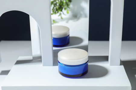 Stylish presentation of face cream against blue backgroundの写真素材