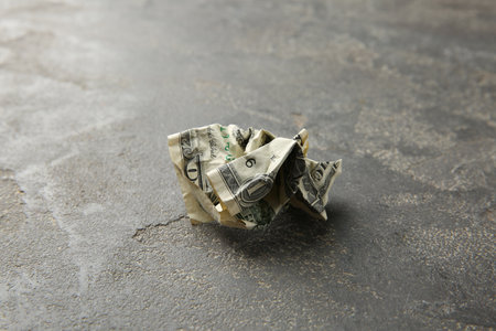 One crumpled dollar banknote on gray table, closeupの写真素材