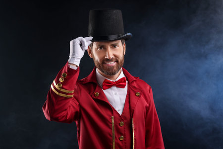 Portrait of performer in red costume and hat on black background with smoke