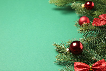Fir tree branches with Christmas decor on green background, closeup. Space for textの写真素材