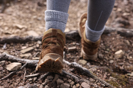 Young hiker in trekking shoes walking outdoors, closeupの写真素材