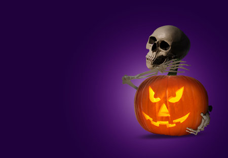 Scary skeleton hugging spooky jack o'lantern on purple background, space for text. Halloween celebrationの写真素材