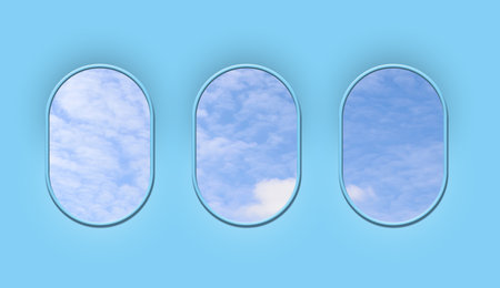 Beautiful sky with clouds, view through airplane windows in light blue sidewall of cabinの写真素材