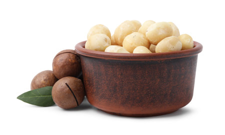 Macadamia nuts in bowl isolated on whiteの写真素材