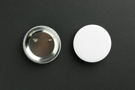 Button badges on black background, flat lay. Mockup for designの写真素材