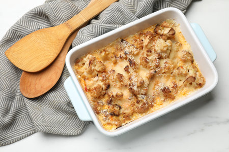 Tasty baked cauliflower in baking dish on white marble table, top viewの写真素材