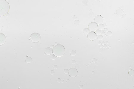 Essential oil bubbles on white background, macro view. Cosmetic productの写真素材