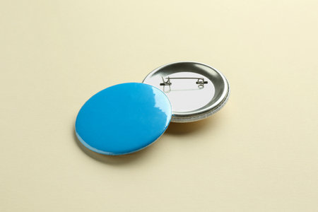 Button badges on beige background. Mockup for designの写真素材