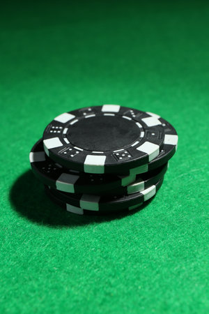 Stack of poker chips on green table, closeupの写真素材