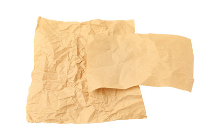 Crumpled kraft paper sheets isolated on whiteの写真素材