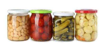 Different pickled products in jars isolated on whiteの写真素材