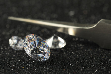 Beautiful dazzling diamonds and tweeters on dark shiny background, closeup