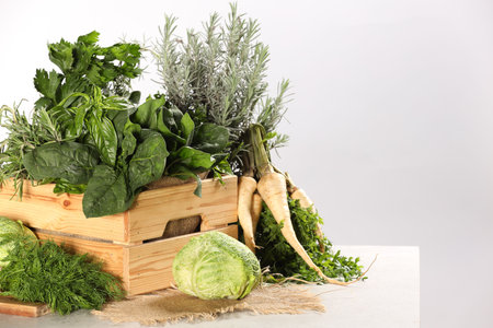 Different fresh herbs and cabbage on white table. Space for textの写真素材