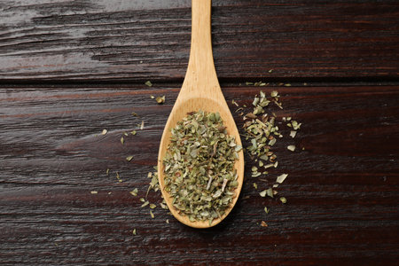 Dried oregano in spoon on wooden table, top viewの写真素材