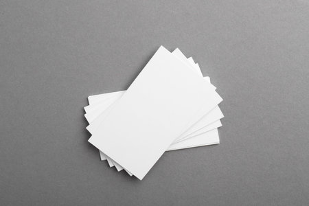 Blank business cards on gray background, top view. Mockup for designの写真素材