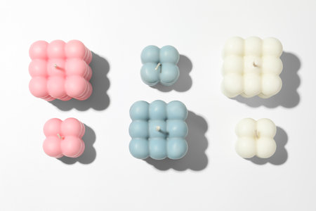 Beautiful bubble candles on white table, flat layの写真素材