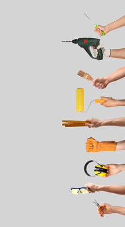 Hands of people with different tools on light gray backgroundの写真素材