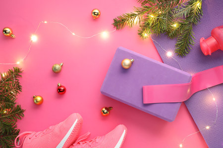 Flat lay composition with yoga mat and Christmas decor on pink backgroundの写真素材