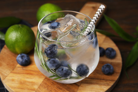 Refreshing water with blueberries and rosemary in glass on table, closeupの写真素材