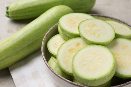 Fresh cut and whole zucchinis on table, closeupの写真素材