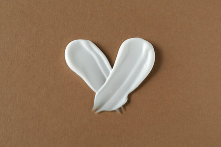 Smears of cosmetic product on brown background, top viewの写真素材