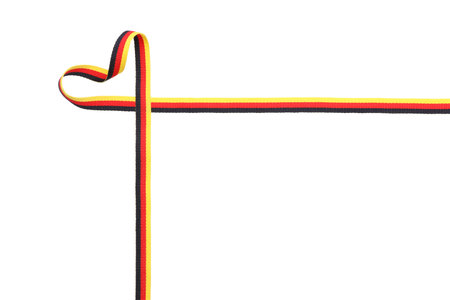 Heart made with ribbon in colors of German flag isolated on white, top viewの写真素材