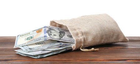 Dollar banknotes in bag on wooden table against white backgroundの写真素材