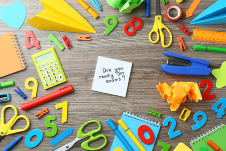 Note with question Are You Ready For Exams and stationery on wooden desk, flat layの写真素材