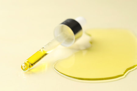 Cosmetic oil and pipette on dark beige background, closeupの写真素材