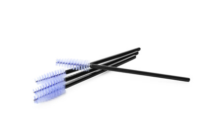 Many disposable makeup brushes isolated on whiteの写真素材