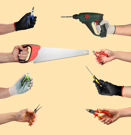 Hands of people with different tools on dark beige background