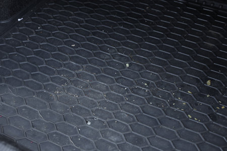 Black rubber car boot liner mat in auto, closeup