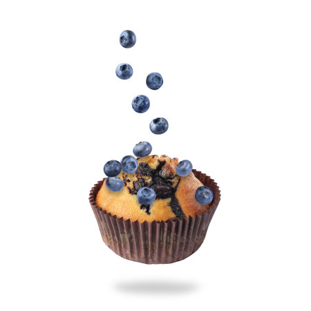 Yummy muffin and blueberries in air on white backgroundの写真素材