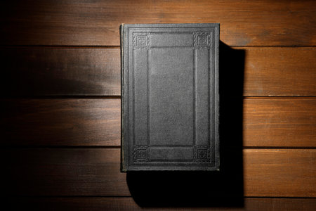 Closed Bible on wooden table, top viewの写真素材