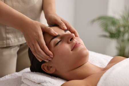 Attractive woman enjoying face massage, closeup. Beauty procedureの写真素材