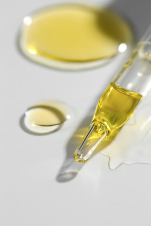 Cosmetic oil and pipette on light gray background, closeupの写真素材