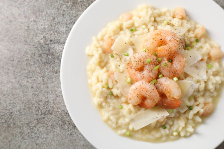 Delicious risotto with shrimps and cheese on gray table, top viewの写真素材