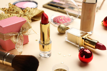Different makeup products and Christmas decor on beige background, closeupの写真素材