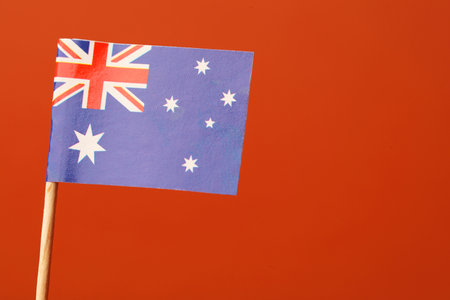 Small paper flag of Australia on orange background, space for textの写真素材