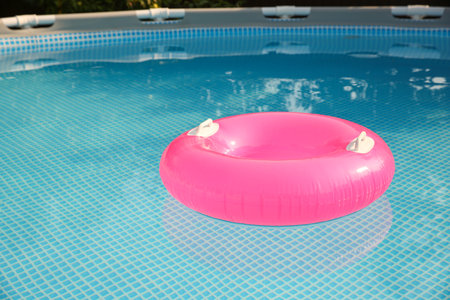 Inflatable ring on water in swimming pool outdoors