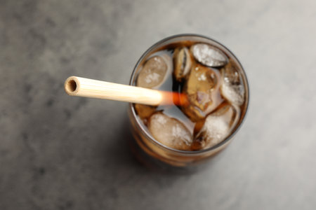 Tasty refreshing drink with straw in glass on gray table, above viewの写真素材