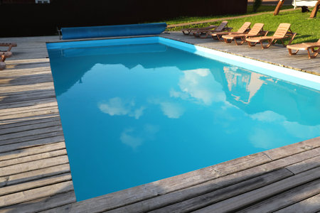 Outdoor swimming pool and sunbeds in luxury hotel