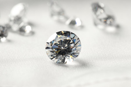 One beautiful shiny diamond on white fabric, closeupの写真素材