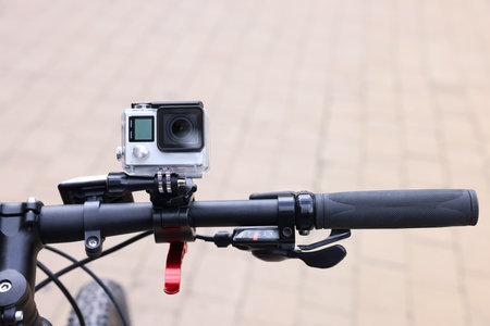 Modern action camera with mount on bicycle outdoors, closeupの写真素材